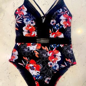 Beautiful floral one piece. Brand new. Never been worn. Tags still on